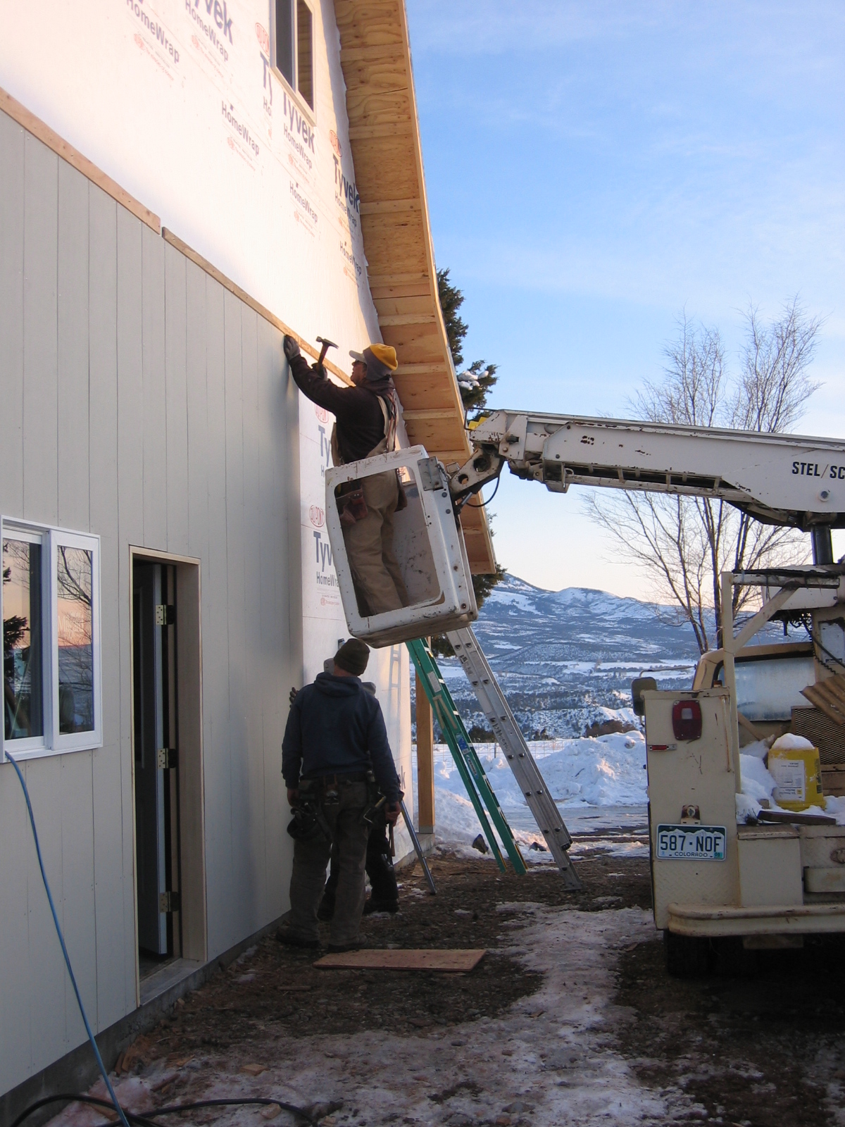 The shop is having board and batten siding installed on the outside. 