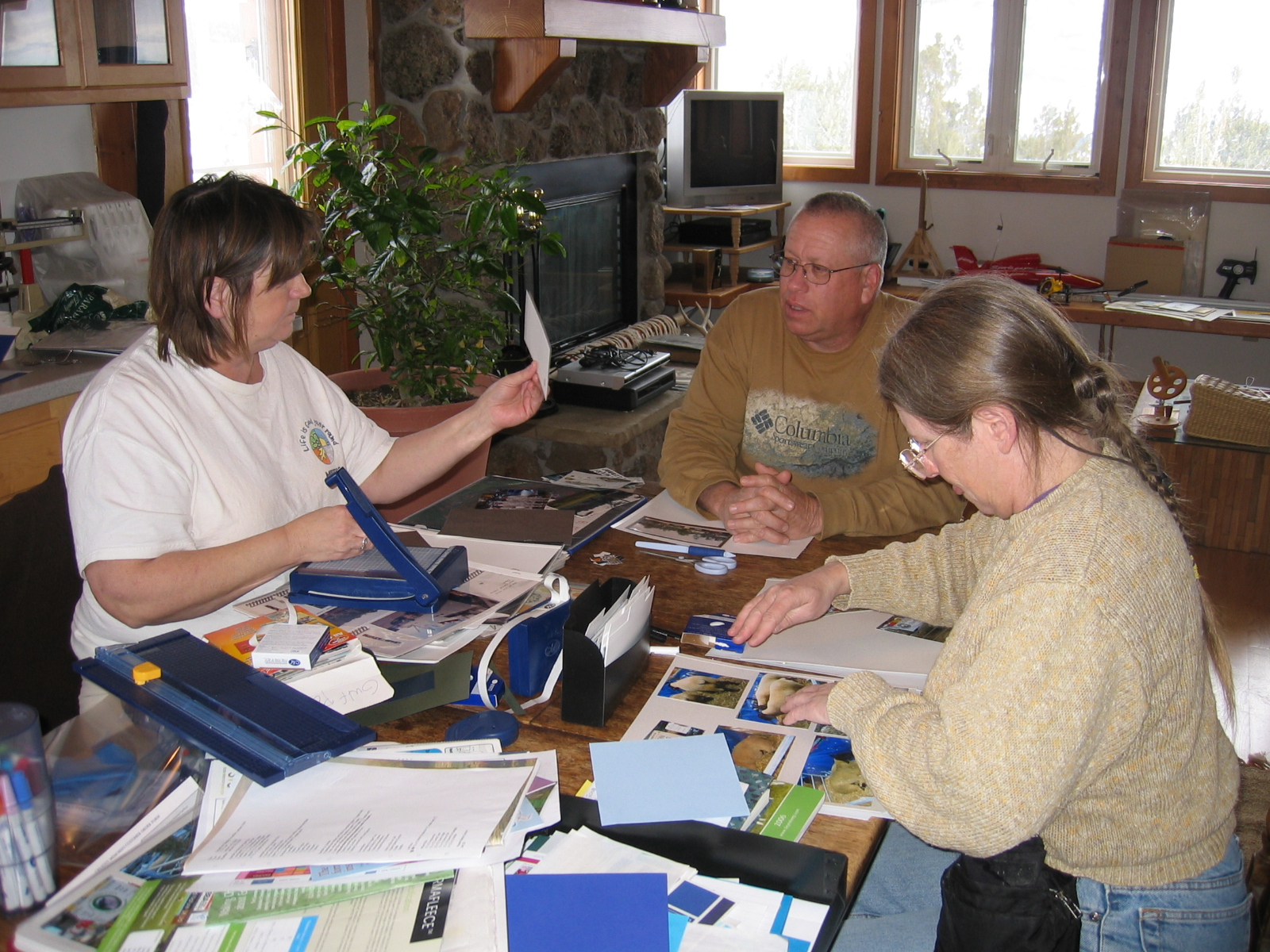 Oogie, Peter, and Ailleen do some scrapbooking together.