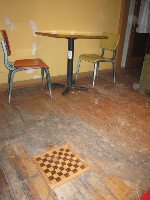 An old chess board has been used to repair the floor in this room. 