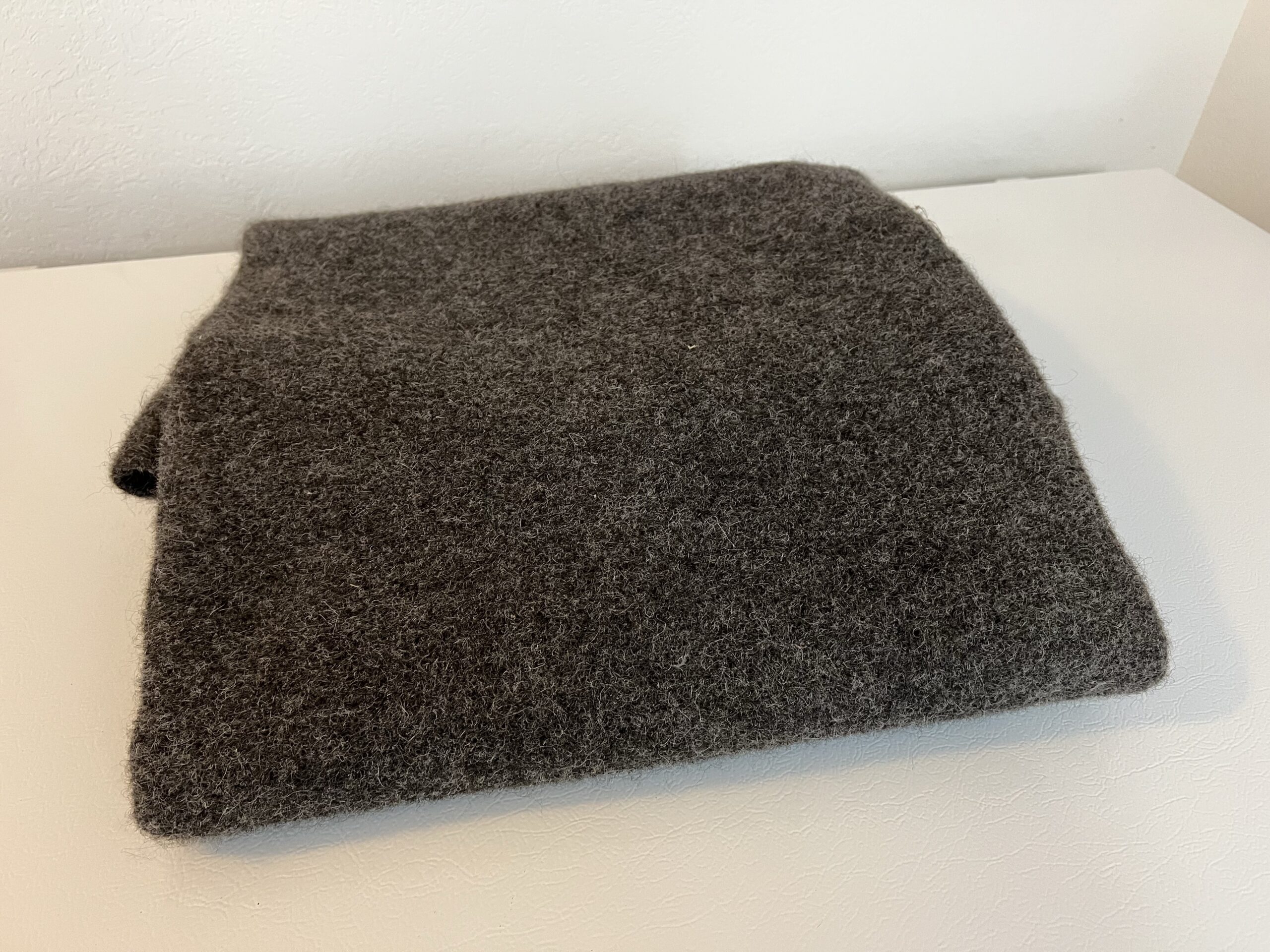 A rectangle of felted wool.